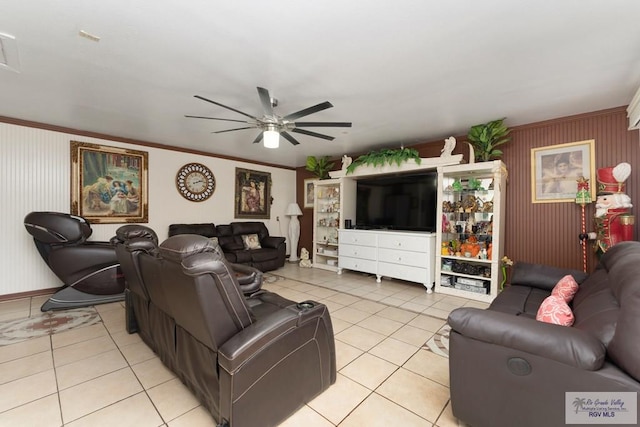 living room with ceiling fan, light tile patterned floors, and ornamental molding