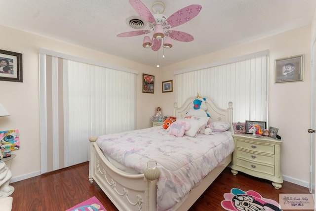 bedroom with ceiling fan and dark hardwood / wood-style flooring