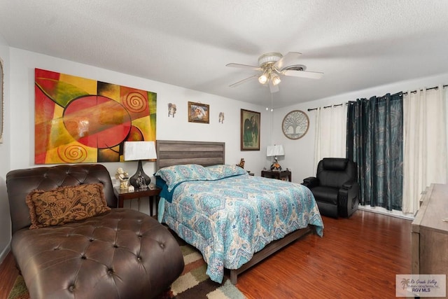 bedroom featuring ceiling fan, wood-type flooring, and a textured ceiling