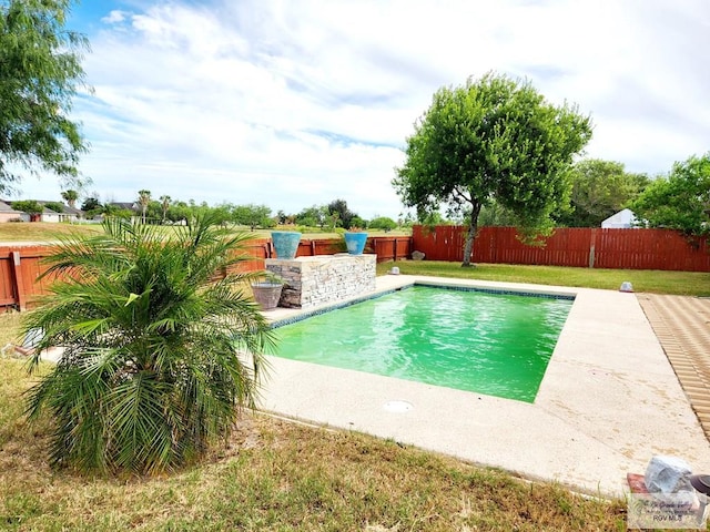 view of pool featuring a lawn