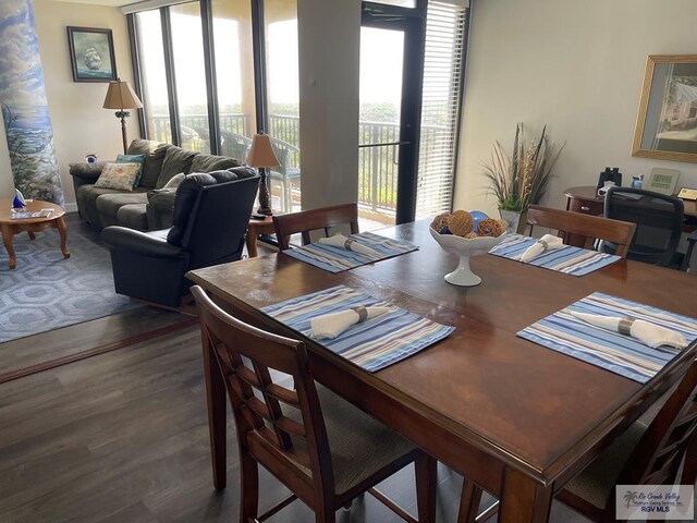 dining space with wood finished floors