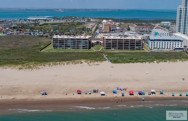 birds eye view of property with a view of city, a water view, and a beach view