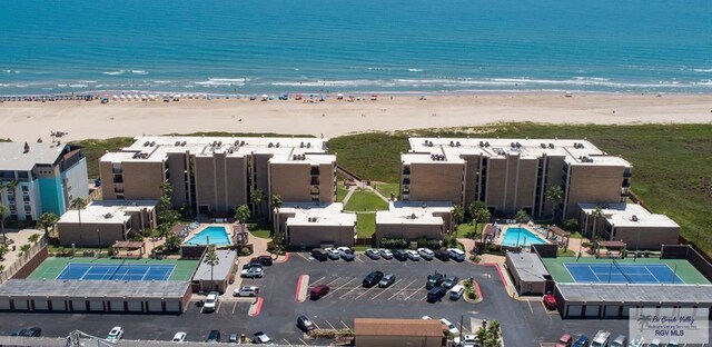 drone / aerial view featuring a water view and a view of the beach