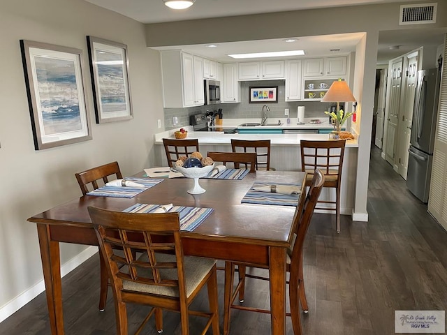 110 Padre Blvd Unit 202, South Padre Island, TX 78597 - dining space featuring dark wood-type flooring