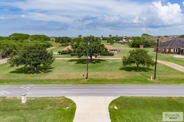 view of property's community featuring a yard