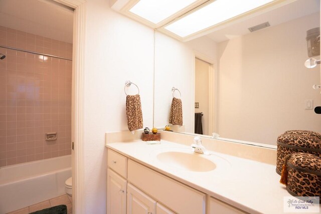 full bathroom with tile patterned floors, vanity, toilet, and tiled shower / bath