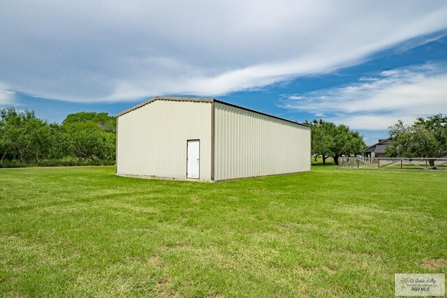 view of outbuilding with a yard