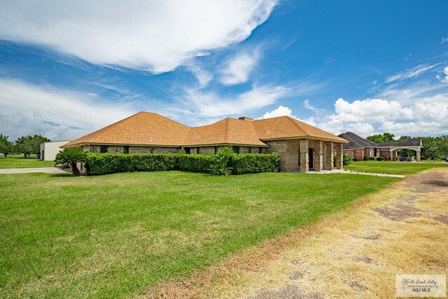 view of side of property with a yard