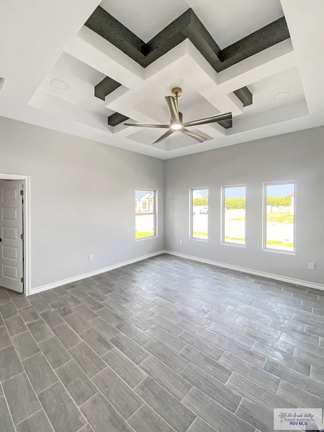 1271 Bridle Way, San Benito, TX 78586 - spare room with coffered ceiling, a ceiling fan, baseboards, dark wood-type flooring, and beamed ceiling