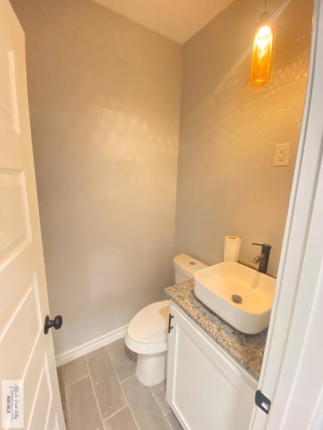 1271 Bridle Way, San Benito, TX 78586 - bathroom featuring vanity, toilet, tile patterned floors, and baseboards