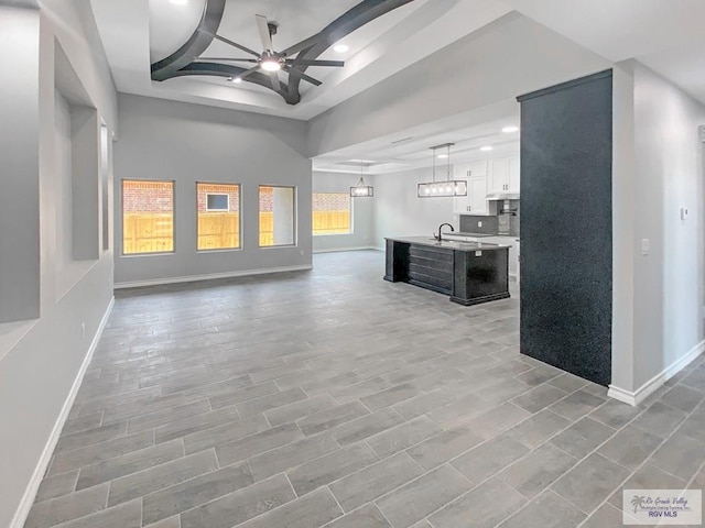 1271 Bridle Way, San Benito, TX 78586 - hallway with baseboards, recessed lighting, a sink, and a raised ceiling