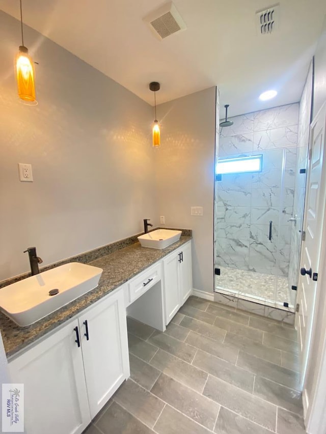 1271 Bridle Way, San Benito, TX 78586 - bathroom featuring a marble finish shower and double vanity