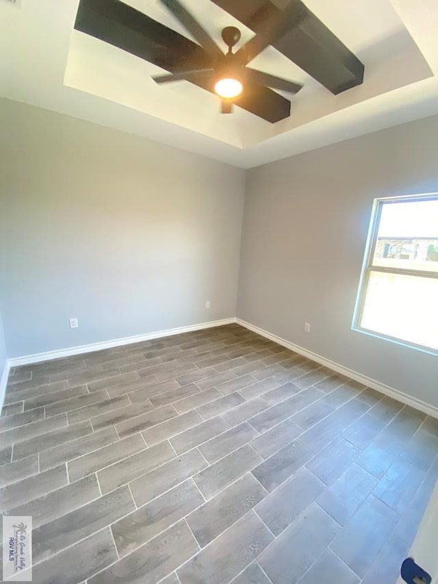 1271 Bridle Way, San Benito, TX 78586 - unfurnished room with a tray ceiling, ceiling fan, baseboards, and wood finish floors