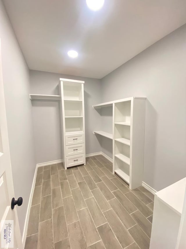 1271 Bridle Way, San Benito, TX 78586 - walk in closet featuring wood tiled floors
