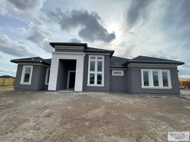 back of house with fence and stucco siding