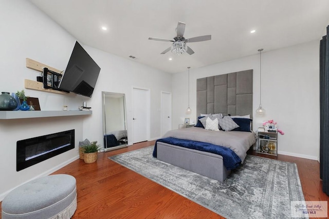 bedroom with ceiling fan and dark wood-type flooring