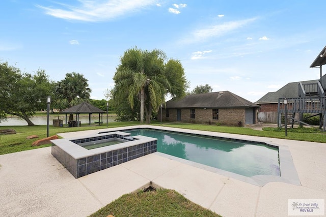 view of pool featuring an in ground hot tub, a gazebo, and a yard