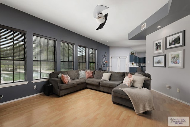 living room featuring light wood-type flooring and ceiling fan