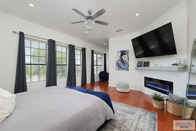 bedroom with wood-type flooring and ceiling fan