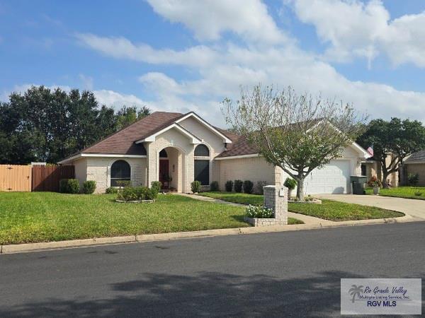 view of front of home featuring a front lawn and a garage