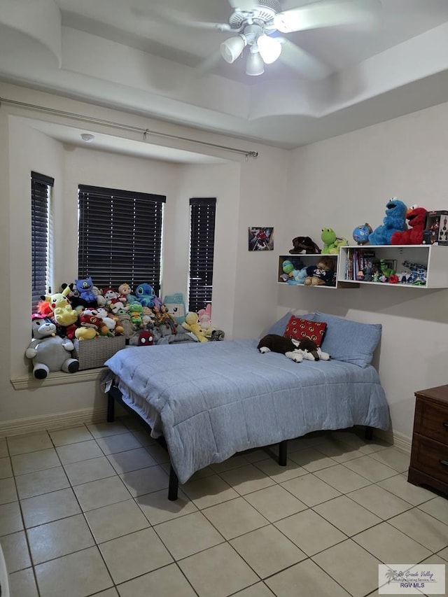7301 Alabama Pine St, Brownsville, TX 78535 - bedroom with light tile patterned flooring, a tray ceiling, baseboards, and ceiling fan