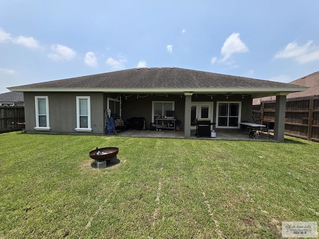 7301 Alabama Pine St, Brownsville, TX 78535 - rear view of house with a fire pit, a patio, and stucco siding
