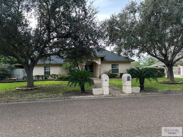 view of front of property with a front lawn