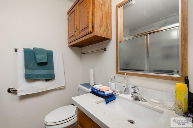 6246 Camelot Dr, Harlingen, TX 78550 - bathroom with vanity, toilet, and a shower with shower door
