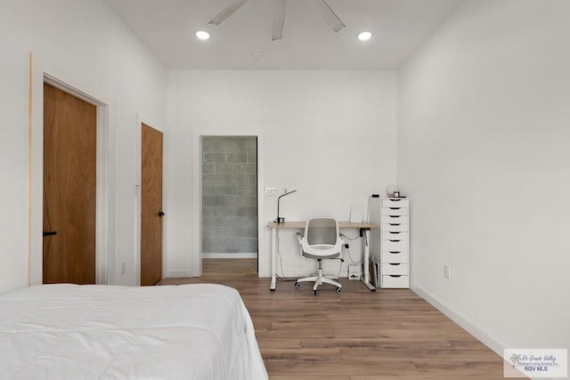 bedroom with hardwood / wood-style floors and ceiling fan