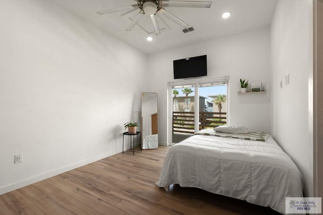 bedroom featuring ceiling fan, access to exterior, and light hardwood / wood-style flooring