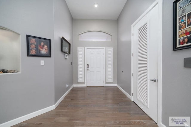 entrance foyer featuring baseboards and wood finished floors