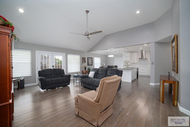 living area with ceiling fan, baseboards, and dark wood-style flooring