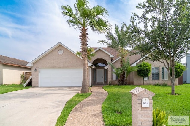 ranch-style house featuring a garage, concrete driveway, brick siding, and a front lawn