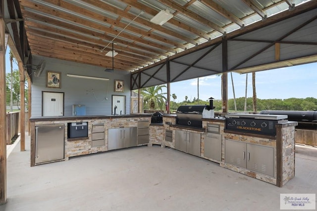 view of patio / terrace featuring area for grilling, exterior kitchen, and sink