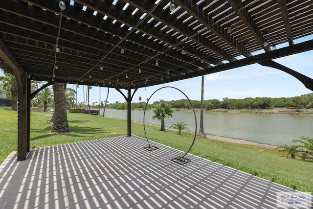 view of patio featuring a pergola and a water view