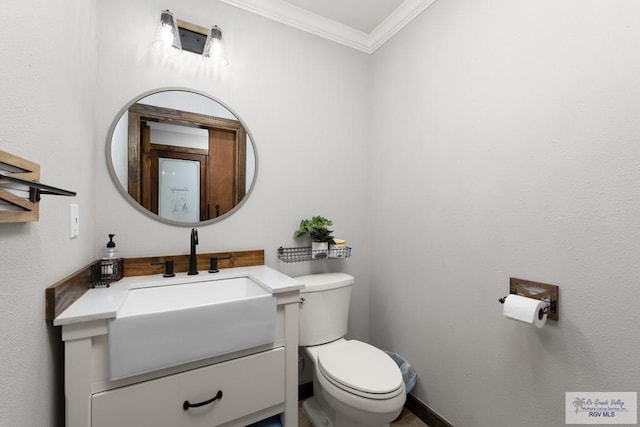 bathroom featuring vanity, toilet, and ornamental molding