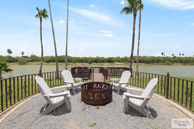 view of patio featuring a fire pit and a deck with water view