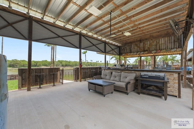 view of patio with exterior bar and an outdoor hangout area