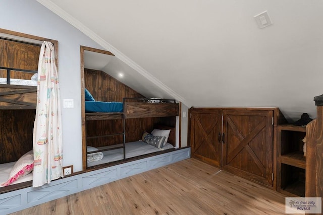 additional living space featuring light hardwood / wood-style flooring and lofted ceiling