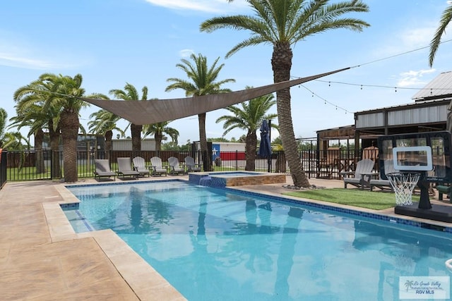 view of swimming pool featuring an in ground hot tub and a patio area