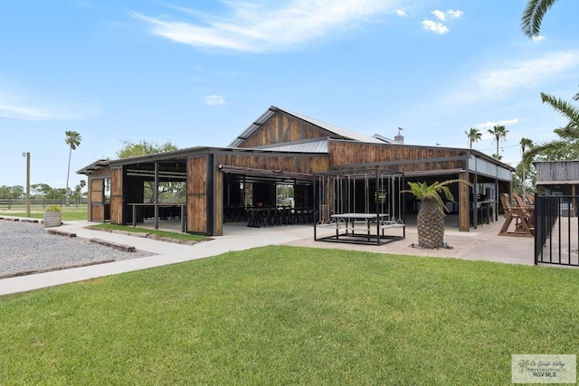 rear view of house with a yard