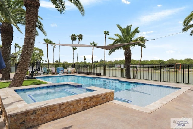 view of swimming pool featuring an in ground hot tub