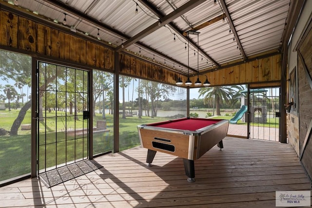 recreation room with wood walls, a water view, billiards, and vaulted ceiling