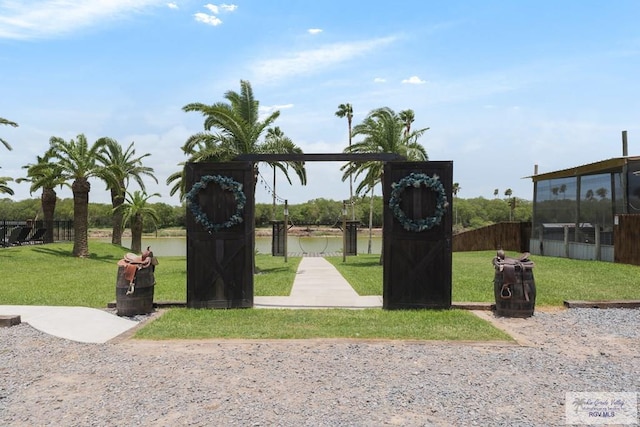 view of property's community with a yard and a water view