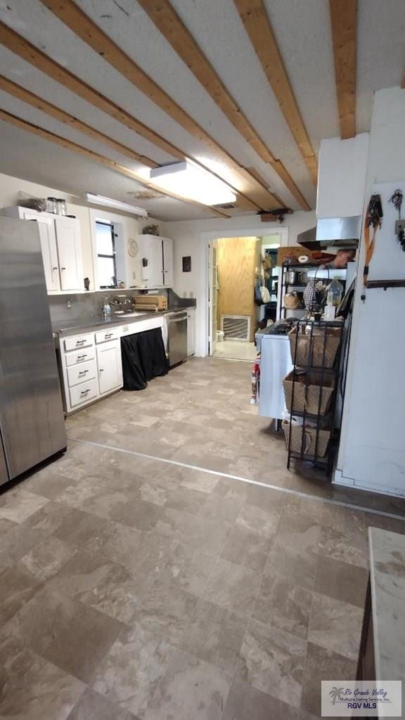 515 Honeydale Rd, Brownsville, TX 78520 - kitchen with freestanding refrigerator, white cabinetry, and light countertops