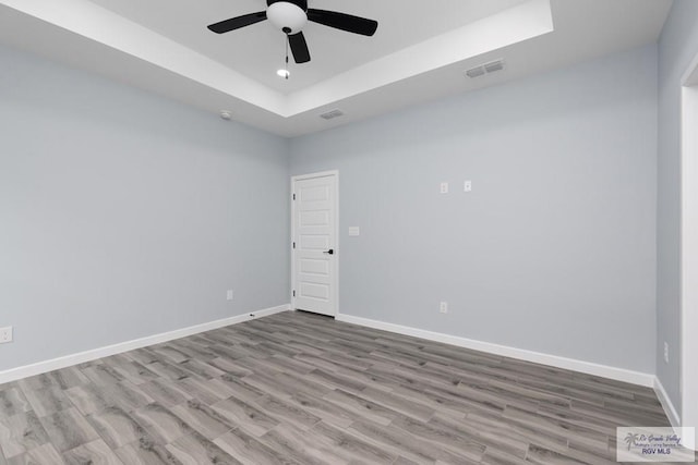 2023 Peace Dr # 23, La Feria, TX 78559 - unfurnished room with a raised ceiling, ceiling fan, baseboards, and wood finished floors