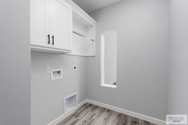 2023 Peace Dr # 23, La Feria, TX 78559 - washroom with hookup for an electric dryer, light wood finished floors, cabinet space, washer hookup, and baseboards