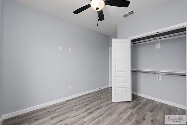 2023 Peace Dr # 23, La Feria, TX 78559 - unfurnished bedroom featuring wood finished floors, a closet, baseboards, and ceiling fan