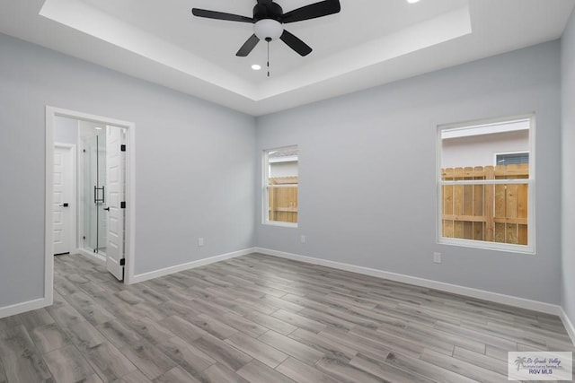 2023 Peace Dr # 23, La Feria, TX 78559 - spare room featuring a tray ceiling, ceiling fan, wood finished floors, and recessed lighting