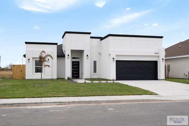 2023 Peace Dr # 23, La Feria, TX 78559 - contemporary home featuring concrete driveway, stucco siding, and an attached garage